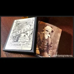 Product image for Dead Rebel Productions' The Curious Case of Amanda Cole, showcasing custom photo cards of happy and upset children alongside a vintage-style handcrafted presentation box, emphasizing the unique mentalism trick. Instant download available.