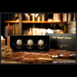 TCC Magic 'The Shell Game' instant download magic video tutorial. A classic shell game setup with three shells and a small ball on a dark surface, ready for a magic trick.