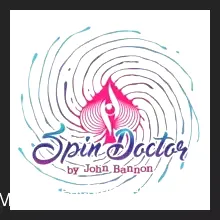 Close-up of a magician's hand holding a fan of playing cards, likely demonstrating a phase of the 'Spin Doctor' card magic trick by John Bannon, with an Ace of Spades visible.