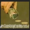 Riku Sawamura demonstrating the Wild Shot coin magic routine with coins in hand, from the instant download tutorial video.