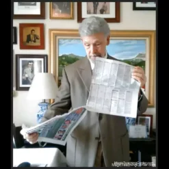 D. Angelo Ferri teaching the classic Slydini's Newspaper Tear magic trick, demonstrating paper restoration on a video screen.
