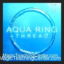 A borrowed ring tied with dental floss submerging into a cup of water, illustrating Gary Jones's Aqua Ring self-working magic trick