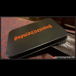 Dead Rebel Productions Angels and Demons magic set, featuring custom angel and demon playing cards fanned out and a metal storage tin with an ambigram logo.