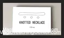 Image of JT's Knotted Necklace illusion in action, depicting three knots visibly appearing, detaching from, and then magically re-merging onto an elegant chain, showcasing the inexplicable magic effect.