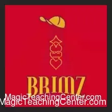 A close-up view of a black baseball cap brim showing a holographic gold sticker revealing the King of Hearts, demonstrating the Brimz card magic trick by Josh Burch.