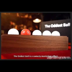 David Penn's The Oddest Ball comedy mentalism prop, a dark wooden stand with several white golf balls and one red golf ball, suggesting an alarm and vibration effect.