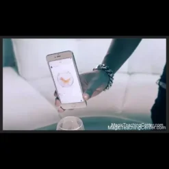 A magician's hand holding a playing card, seemingly pulling it out from an Instagram feed displayed on a smartphone screen, illustrating the SansMinds The Instagram Project illusion.