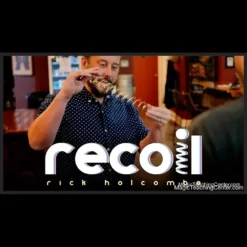 A magician's hand holding a solid metal ball next to a Slinky® spring, visually representing the metal transformation effect taught in Rick Holcombe's Recoil instant download magic trick.