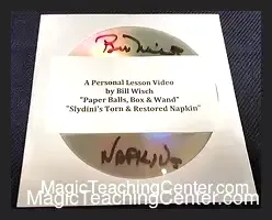 Bill Wisch demonstrating the Paper Balls, Box & Wand magic trick, holding a wand and box with paper balls, representing his instructional DVD on Slydini's classic routines.