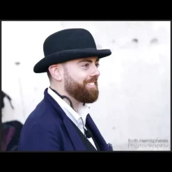 Nathan Earl performing street magic, captivating an audience during a busking performance, illustrating techniques from 'Something from Nothing' lecture.